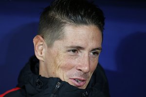 Atletico's Fernando Torres sits on the substitutes bench before a Spanish La Liga