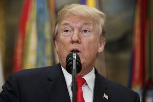 In this Dec. 12, 2017, photo, President Donald Trump speaks before signing the National Defense Authorization Act for Fiscal Year 2018, in the Roosevelt Room of the White House in Washington.