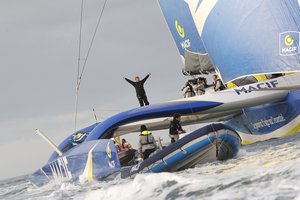 French skipper, Francois Gabart, waves aboard his 30m MACIF trimaran as he celebrates his world record off Brest harbor, western France, Sunday, Dec. 17, 2017.