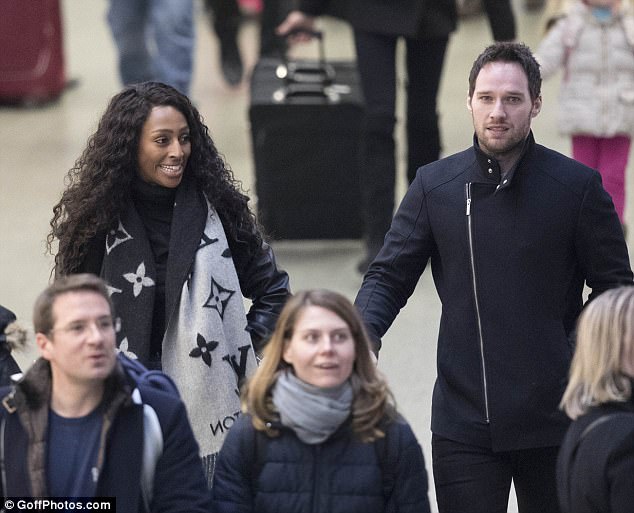 Giddy: She seemed to be recognised as she walked through arrivals at Kings Cross