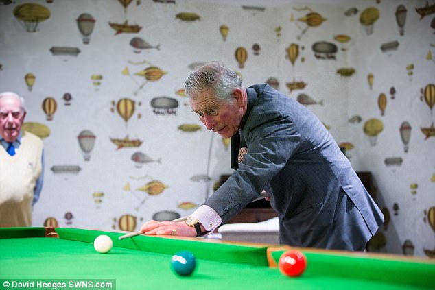 Prince Charles indulged in a game of pool as he visited the home