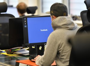 File - Employees of the Competence Call Center (CCC) work for the Facebook Community Operations Team in Essen, Germany, Thursday, Nov. 23, 2017.