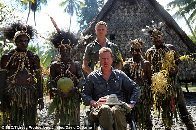 Benedict and co-presenter Frank Gardner with members of the Kandengi village, during filming for the BBC's Birds of Paradise: The Ultimate Quest, in New Guinea