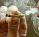 A man enjoys a joint in Toronto, Canada, where weed will become legal for personal use in 2018.