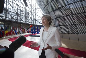 British Prime Minister Theresa May speaks with the media as she arrives for an EU summit at the Europa building in Brussels on Friday, June 23, 2017.