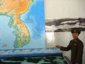 DPRK soldier pointing to the DMZ. In 2002, United States president George W. Bush labeled North Korea part of an "axis of evil" and an "outpost of tyranny".