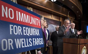 Senate Minority Leader Chuck Schumer, D-N.Y.and other Senate Democrats, from left, Sen. Al Franken, D-Minn., Sen. Elizabeth Warren, D-Mass., Sen. Catherine Cortez Masto, D-Nev., Sen. Jack Reed, D-R.I., and Sen. Patrick Leahy, D-Vt., discuss consumer protections in the wake of a massive data breach at Equifax and a scandal at Wells Fargo, at the Capitol in Washington, Wednesday, Sept. 27, 2017. Executives for both Wells Fargo and Equifax will testify in Senate committees next week.  (AP Photo/J. Scott Applewhite)