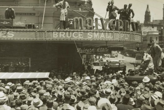 Crowd of fans gathered outside a bicycle store