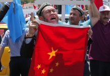 Uighurs living in Turkey and Turkish supporters chant slogans on July 5, 2015, as they hold a Chinese flag before burning it during a protest near China's consulate in Istanbul. Photo: Lefteris Pitarakis / Associated Press