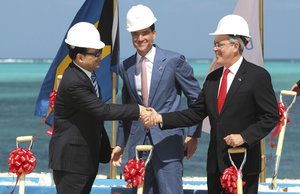 In this Feb. 21, 2011 file photo, Baha Mar Resorts CEO Sarkis Izmirlian, center, stands between Export-Import Bank of China President Li Ruogu, left, and Bahama's Deputy Prime Minister Brent Symonette during the groundbreaking ceremony for a Baha Mar resort in Nassau, Bahamas