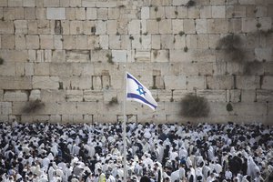 Covered in prayer shawls Jewish men of the Cohanim priestly caste participate in a blessing during the Passover holiday, in front of the Western Wall, the holiest site where Jews can pray in Jerusalem's Old City, Thursday, April 13, 2017.