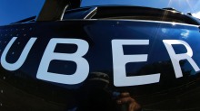 FILE - In this Monday, Sept. 12, 2016, file photo, a self-driving Uber sits ready to take journalists for a ride during ...