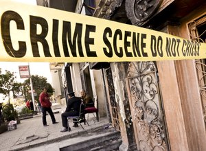 Egyptian policemen guard the scene of the El Sayad restaurant which was attacked in Cairo, Egypt, Friday, Dec. 4, 2015.