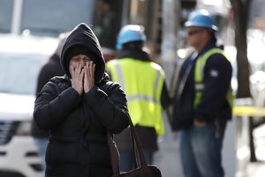 Nilda Guerrero, a friend of the superintendent of an apartment apartment building where more than 10 people died in a fire a day earlier in the Bronx borough of New York, walks away after trying to visit the building Friday, Dec. 29, 2017.