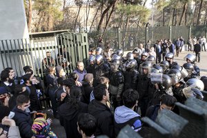 In this photo taken by an individual not employed by the Associated Press and obtained by the AP outside Iran, anti-riot Iranian police prevent university students to join other protesters over Iran weak economy, in Tehran, Iran, Saturday, Dec. 30, 2017.