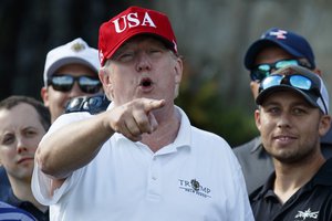 President Donald Trump speaks as he meets with members of the U.S. Coast Guard, who he invited to play golf, at Trump International Golf Club, Friday, Dec. 29, 2017, in West Palm Beach, Fla.