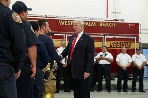 President Donald Trump shakes hands with first responders at West Palm Beach Fire Rescue, Wednesday, Dec. 27, 2017, in West Palm Beach, Fla.