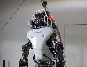 File - The Defense Advanced Research Projects Agency’s Robotics Challenge teams using DARPA’s Atlas robot, developed by Boston Dynamics, met in Waltham, Mass., in January to learn about upgrades to the robot.