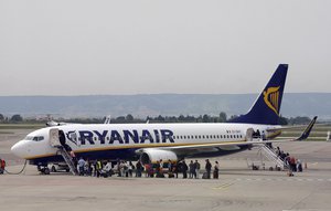 FILE- In this Wednesday, May 13, 2015 file photo passengers disembark a Ryanair plane, at the Marseille Provence airport, in Marignane, southern France.