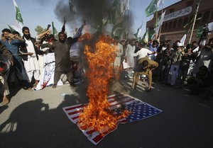 Supporters of Pakistani religious group rally to condemn a tweet by U.S. President Donald Trump in Karachi, Pakistan, Tuesday, Jan. 2, 2018.