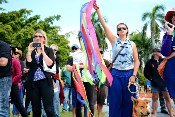 Anti-racism demonstrator in a field of Reclaim Australia protesters in Mackay, July 19, 2015