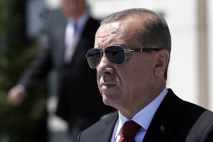 Turkey's President Recep Tayyip Erdogan walks before a welcome ceremony for Indonesian President Joko Widodo at the presidential palace in Ankara, Turkey, Thursday, Juy 6, 2017.