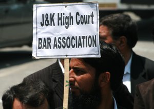 A member of the Jammu and Kashmir High Court Bar Association (JKHCBA) carries a placard during a protest march in Srinagar May 28, 2009. Dozens of JKHCBA members tried to march to the office of the United Nations Military Observers Group in India and Pakistan to highlight what JKHCBA says is the continuous human rights violation by Indian security forces on Kashmiris.