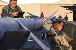 File - Airmen inspect an AIM-120 medium-range air-to-air missile during the quarterly load crew competition at Nellis Air Force Base, Nev., Jan. 5, 2018.