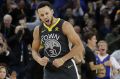 Golden State Warriors guard Stephen Curry reacts after scoring during the first half of the team's NBA basketball game ...