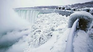 Visitors take photographs at the brink of the Horseshoe Falls in Niagara Falls, Ontario, as cold weather continues ...