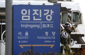 A South Korean army soldier passes by a signboard showing the distance to the North Korea's capital Pyongyang and to South Korea's capital Seoul from Imjingang Station in Paju, South Korea, near the border with North Korea, Thursday, Jan 4, 2018.