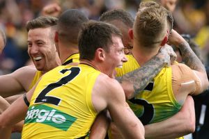 Dylan Grimes (No.2) embraces his teammates after the siren in the 2017 AFL grand final.