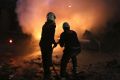 White Helmet civil defence workers extinguish a fire following a bombing in Idlib on Sunday.