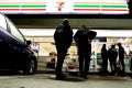 US Immigration and Customs Enforcement agents serve an employment audit notice at a 7-Eleven convenience store in Los ...