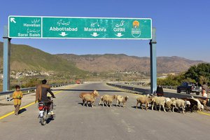 Pakistani motorcyclist drives on a newly built Pakistan China Silk Road in Haripur, Pakistan.