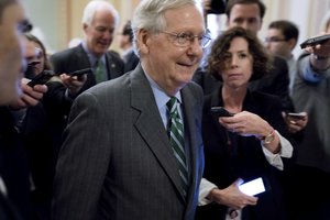 Senate Majority Leader Mitch McConnell of Ky. walks on to the Senate floor on Capitol Hill in Washington, Thursday, June 22, 2017, following a meeting with Senate Republicans on a health reform bill. Senate Republicans would cut Medicaid, end penalties for people not buying insurance and erase a raft of tax increases as part of their long-awaited plan to scuttle Barack Obama's health care law.