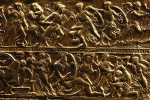 Battle scenes appear in a detail from a golden bow-case, believed to have belonged to a Scythian princess, that was found in a richly furnished tomb believed to belong to ancient Greek King Philip II of Macedon, is displayed at Vergina museum, northern Greece, on Tuesday, Oct. 7, 2014. Philip II reigned from 359 to 336 B.C. expanding his kingdom to include Greece's perennially squabbling city states. His son and successor, Alexander the Great, who distinguished himself in Philip's Greek campaigns, expanded Macedonian rule at the head of a Greek army, reaching as far as the borders of India. (AP Photo/Petros Giannakouris)