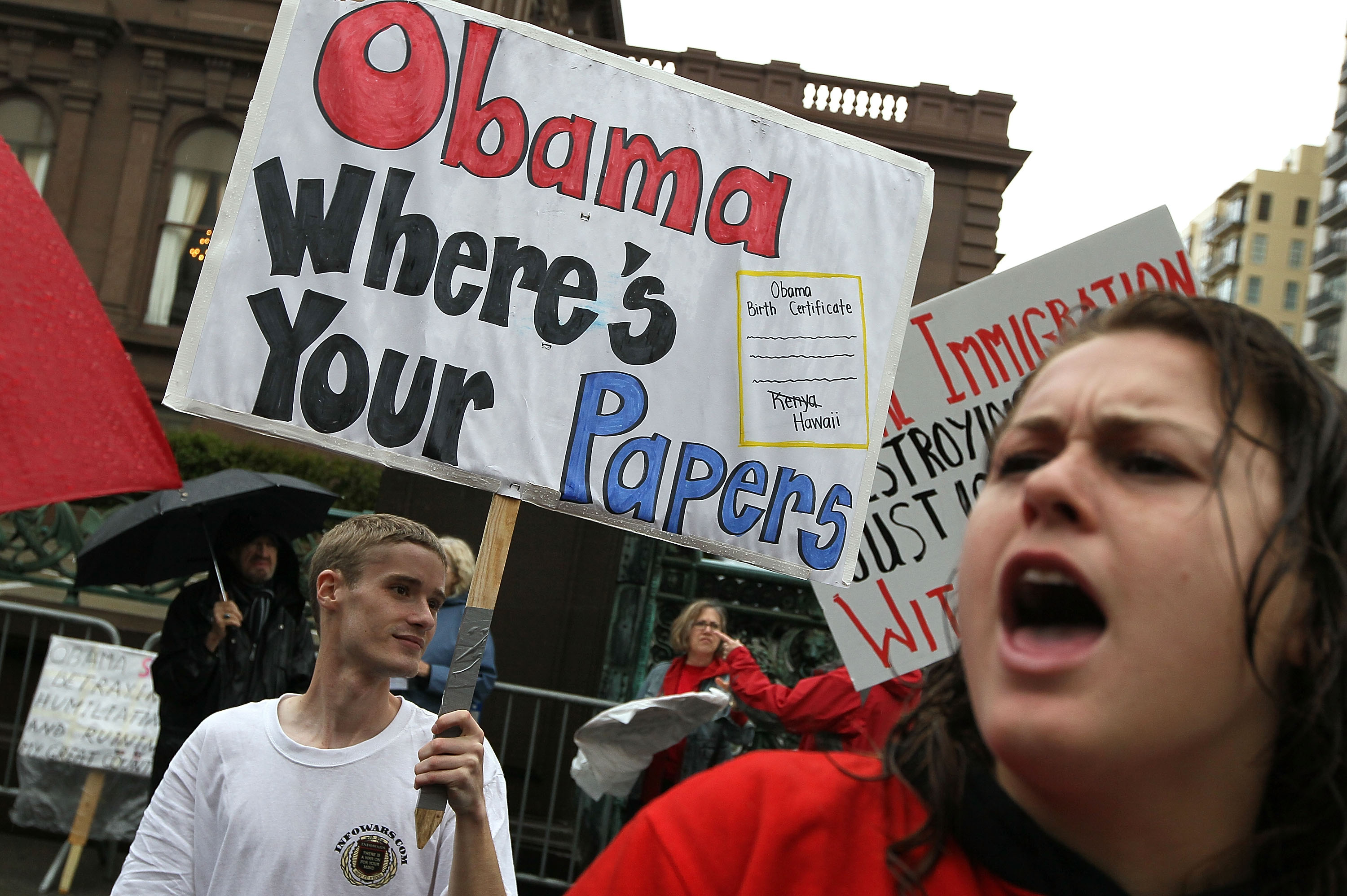 A Tea Party supporter holds a sign asking 