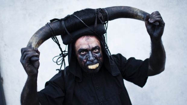 A man dressed as a devil from Luzon group parades with others during the Iberian mask festival in Viana do Bolo, ...