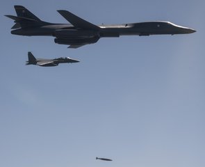 File - A U.S. Air Force B-1B Lancer, flanked by Republic of Korea Air Force F-15K Slam Eagles, drops a 2,000 pound live munition at Pilsung Training Range, South Korea as a part of a show of force mission in response to unlawful North Korean ballistic missile tests, 18 September, 2017.