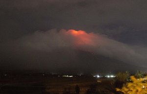 In this Sunday, Jan. 14, 2018, photo provided by Earl Recamunda, an orange glow is seen at the cloud-shrouded crater of Mayon volcano at Legazpi city, Albay province, about 340 kilometers (210 miles) southeast of Manila, Philippines.