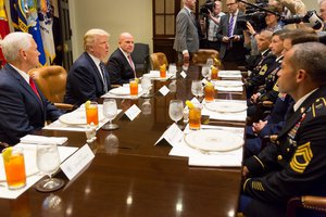 File - From left, Vice President Mike Pence, President Donald J. Trump, and National Security Advisor Army Lt. Gen. H.R. McMaster talk with service members during a lunch in the Roosevelt Room at the White House, July 18, 2017.