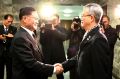 The head of the North Korean delegation, Kwon Hook Bong, shakes hands with his South Korean counterpart, Lee Woo-sung, ...