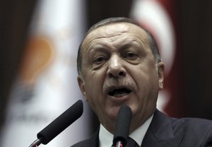 Turkey's President Recep Tayyip Erdogan addresses his supporters at the parliament in Ankara, Turkey, Tuesday, Nov. 21. 2017.