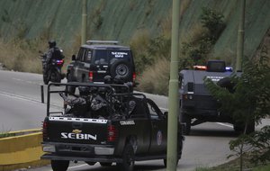 Members of the Venezuelan Bolivarian Intelligence Service arrive to the Junquito highway during an operation to capture Oscar Perez, according to officials, in Caracas, Venezuela, Monday, Jan. 15, 2018.