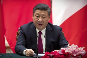 Chinese President Xi Jinping speaks during a joint press briefing with French President Emmanuel Macron, not shown, at the Great Hall of the People in Beijing, Tuesday, Jan. 9, 2018. (AP Photo/Mark Schiefelbein, Pool)