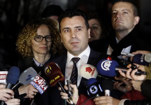 Macedonian Social-democrats leader Zoran Zaev, center, talks to the media after the meeting that EU enlargement commissioner Johannes Hahn had with main four Macedonian political leaders on the implementation of last year's Western-brokered deal to solve a deep political crisis, in front of EU ambassador’s residence in Skopje, Macedonia, early Saturday, Jan. 16, 2016