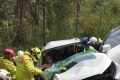 Emergency services attempting to free the 17-year-old man from his vehicle.