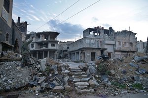 A Syrian soldier calls out to his colleague as he walks through a devastated part of Bab Dreib neighborhood in the old city of Homs, Syria, Tuesday, Jan. 16, 2018.