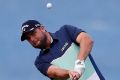 Focused: Marc Leishman hits from the fourth fairway during his round of 67.